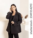 Small photo of Woman in black oversize jacket. Classic women's suit for office, school, university, business meetings
