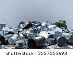 Metal tins, cans and jar garbage from household on the table. City home trash made of aluminum. Empty used, food and drink steel packaging waste and scrap discarded sorted and ready to recycle. 