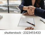 Small photo of Job interview. Two businessmen shake hands to submit resume documents. HR manager shakes hands congratulating job candidates for successful job application close up pictures