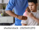 Small photo of Close up patient hand doing stretching with physiotherapy to help in clinic room Therapist treats injured man with rotator cuff stretching method