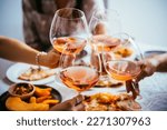 Friends enjoy a home rose wine party with pizza.