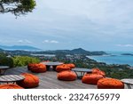 Small photo of The jungle club samui ,Orange beanbag place to relax Sea view Chaweng beach in Koh Samui, Thailand. The scenery of seascape and bay with city and forest of coconut trees beautiful blue sky