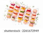 Small photo of Chicken Skewers breast fillet meat.Uncooked mixed meat skewer.Skewers with pieces of raw meat,red,yellow,green pepper.Top view.Raw chicken skewers with vegetables,peppers,onions,on a white background.
