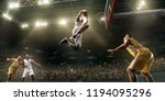 Small photo of Basketball players on big professional arena during the game. Basketball player makes slum dunk