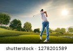 Small photo of Male golf player on professional golf course. Golfer with golf club taking a shot