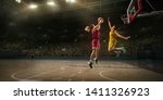 Small photo of Female basketball players fight for the ball. Basketball player makes slam dunk on big professional arena during the game