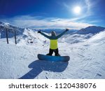 Winter sport activity.Happy woman with snowboard holding hands up open, freedom, enjoying a winter, cold season. Having fun on the snow, mountains, ski area, Remarkables, New Zealand, Queenstown