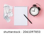 Notebook And Clock On...