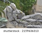 Small photo of A sandstone sculpture which shows a suffering female person on his deathbed on a cemetery in Athens-Greece.