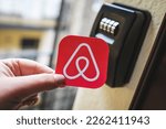 Small photo of Airbnb logo next to a smart key lock box. Contactless check-in to the holiday apartment, short term accommodation bookings for tourists. Budapest, Hungary - February 3, 2023.