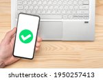 Small photo of cell phone confirmation. Smartphone with green checkmark on screen, validated, confirmed, completed, approved. Confirmed Smartphone Order Success. hand hold phone with green checkmark confirmation