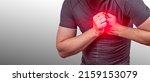 Small photo of heart attack. Severe heartache, man suffering from chest pain, having heart attack or painful cramps, pressing on chest with painful. Man clutching his chest from acute pain. Heart attack symptom