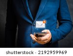 Businessman holding cellphone with virtual letter icon for application notification alert concept. Hand of businessman using smartphone for email with notification alert, Online communication concept