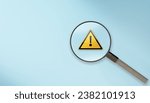 Small photo of magnifier glass with yellow triangle caution warning sign for notification error and maintenance concept. magnifying glass and with exclamation attention sign. Root cause analysis or solving problem