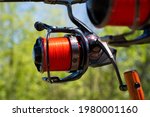 Small photo of Basia Fishing Reels with red line on carp rods, on rodpod