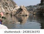 Small photo of The Narmada, making its way through the Marble Rocks, Narrows down and then plunges in a waterfall known as Dhuandhar or the smoke cascade. So powerful is the plunge that its roar is heard from a far
