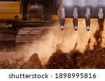 Small photo of Backhoe working by digging soil at construction site. Bucket teeth of backhoe digging soil. Crawler excavator digging on soil. Excavating machine. Earth moving machine. Excavation vehicle.