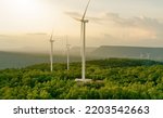 Small photo of Selective focus on wind farm. Wind energy. Wind power. Sustainable, renewable energy. Wind turbines generate electricity. Windmill farm on mountain. Green technology. Sustainable resources.