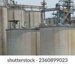 Small photo of Animal feed factory. Agricultural silos, grain storage silos. Agriculture industry. Rural agribusiness. Grain storage innovation. Agricultural silos at animal feed factory. Sustainable farming.