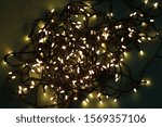 Small photo of White-hot, yellow lights, New Year's garland, Christmas lights.
