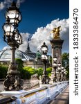 Small photo of Paris, France - May 23, 2020: Famous street lantern on the Alexandre III Bridge in Paris