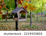 Wooden bird feeder on a tree...