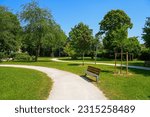 Small photo of Footpath in the Parc des Bienfaites ("Bienfaites Park") in the city of Brie-Comte-Robert in Seine et Marne near Paris, France - Green meadow with trees to relax
