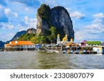 Floating fishing village of Koh Panyee made of houses on stilts in Phang Nga Bay among limestone karst sea cliffs in the Andaman Sea, Thailand