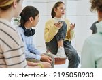 Portrait of teenage girl sharing feelings in support group circle for children
