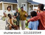 Portrait of African American family waving to guests after Summer party