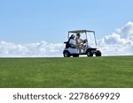 Minimal background image of sporty couple driving golf cart across field with center line horizon, copy space