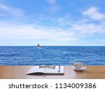 Sea, sky, white clouds and fishing boats.
Nature, with coffee cup, tablet, glasses, diary, book, pen And Writing notebook to record the memories of the holidays., in Thailand.