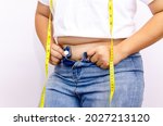 Small photo of Beautiful fat woman with tape measure She uses her hand to squeeze the excess fat that is isolated on a white background. She wants to lose weight, the concept of surgery and break down fat under