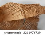 Small photo of Honeycomb Environmental friendly paper hexagonal shape made of cardboard recycled craft paper strength and lightweight bubble wrapping transparent glass bowl for protective packaging
