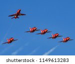 Small photo of CARDIFF, WALES - JULY 2018: Hawk jets of the Royal Air Force Red Arrows formation display team arriving at Cardiff Wales Airport ahead of a display in south Wales with the team leader breaking away.