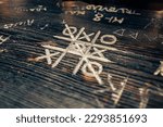 Small photo of A game of tic-tac-toe on a wooden bar counter. A tic-tac-toe game for two. Combinatorial theory. Children's game on paper. Bar entertainment.