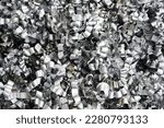Small photo of Steel scrap materials recycling. Aluminum chip waste after machining metal parts on a cnc lathe. Closeup twisted spiral steel shavings. Small roughness sharpness