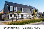 Small photo of Newly build houses with solar panels attached on the roof against a sunny sky Close up of a new building with black solar panels. Zonnepanelen, Zonne energie, Translation: Solar panel, , Sun Energy