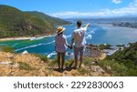 Small photo of A panoramic view of the lagoon of Knysna, South Africa. beach in Knysna, Western Cape, South Africa. A couple of man and woman on a trip at the garden route in South Africa