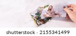 Small photo of woman sitting at desk and looking at printed photos, remember nostalgia for a day of rest. photography cards, background. Mock up. banner