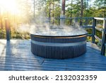 Small photo of Modern big barrel outdoor hot tub in the middle of forest. The hot tub's soothing warm water relaxes muscles and eases tensions, so your worries can simply melt away.