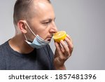 Small photo of Anosmia or smell blindness, loss of the ability to smell, one of the possible symptoms of covid-19, infectious disease caused by corona virus. Man Trying to Sense Smell of a Lemon