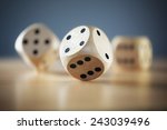 Rolling three dice on a wooden desk