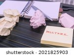 Small photo of Mistake written on sticky notes. Learning, wrong, blooper, error message, regret sayings background. Fault, defect, careless, lesson correction and reconciliation concept for business finance industry