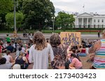 Small photo of Washington, DC - June 26, 2022: Group sitting in front of the White House is protesting the Roe v Wade ruling by the Supreme Court. One sign says "I will aid and abet abortion."