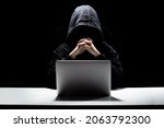 A man without a face behind a laptop, a hacker attack