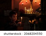 Little Boy Holding Candle On...