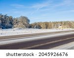 Beautiful winter landscape view. Snowy highway  on frosty forest trees and blue sky background. Sweden. 