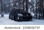 Small photo of Helsinki, Finland - December 15, 2022 Volkswagen Golf Mk7 GTI black. in the forest in snowy winter