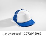 Trucker cap, snapback, blue with white front, blue mesh, firm. Isolated on white. Mock-up for branding